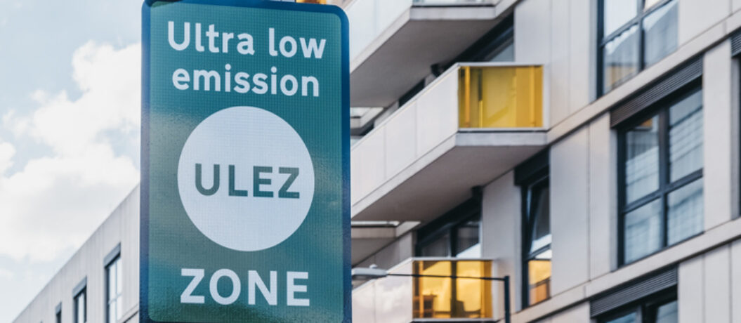 Signs indicating Ultra Low Emission Zone (ULEZ) on a street in London, UK.