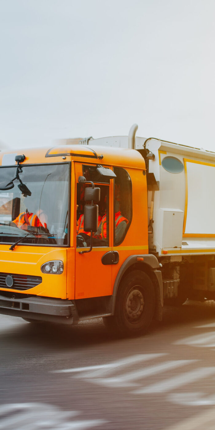 Garbage truck driving in urban environment in United Kingdom