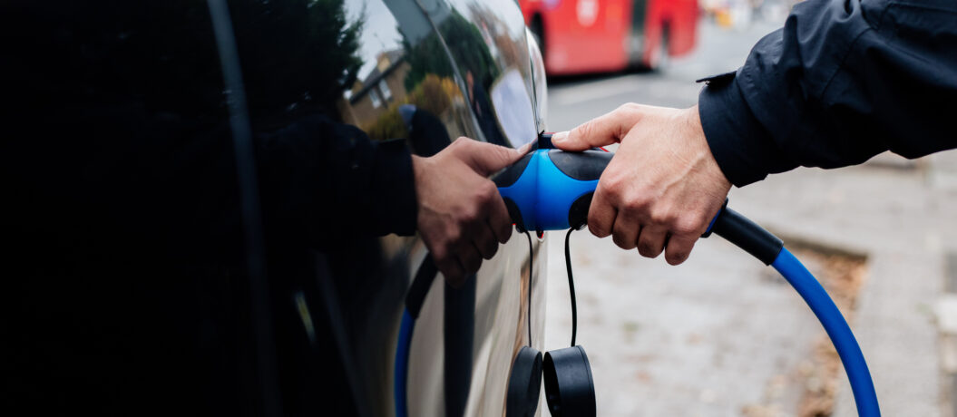Man Holding Electric Car Charger